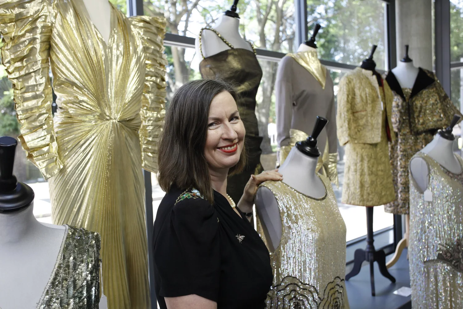 Kerry Taylor surrounded by couture garments, from the auction house’s photographic archive